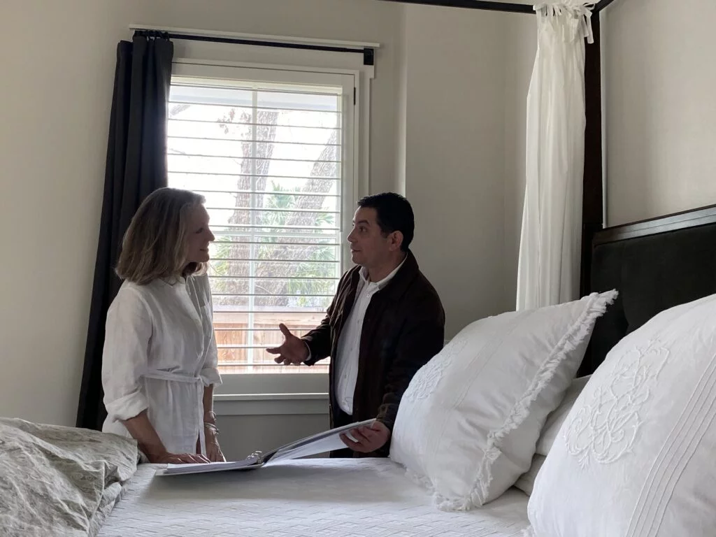 Dr. Carlos Loredo Ritter explaining to a client how to protect her from exposure to EMF during nighttime in her own bedroom
